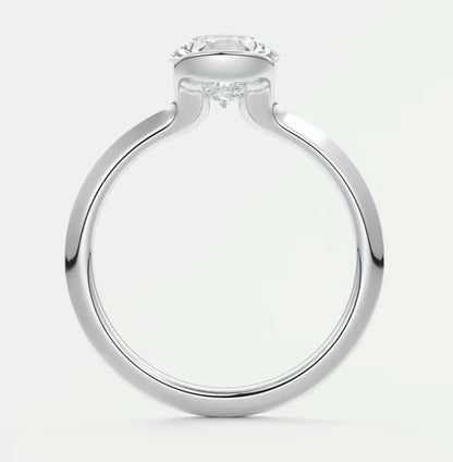 White gold engagement ring with a round diamond center stone and delicate floral accents.