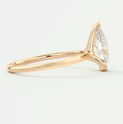 18-karat gold engagement ring with marquise-cut diamond.