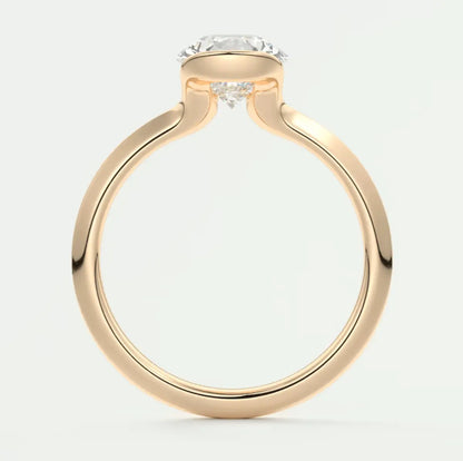 18k rose gold engagement ring with a round diamond center stone and small diamonds on the band.