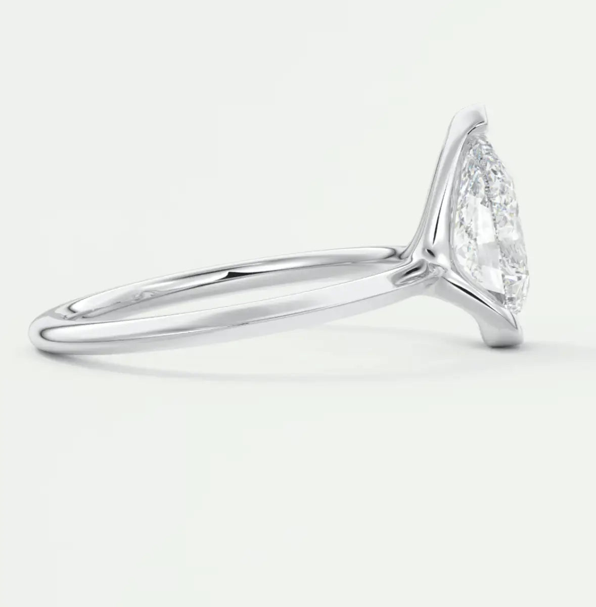 18k white gold diamond engagement ring with a marquise-cut center stone and pave-set diamonds on the band.