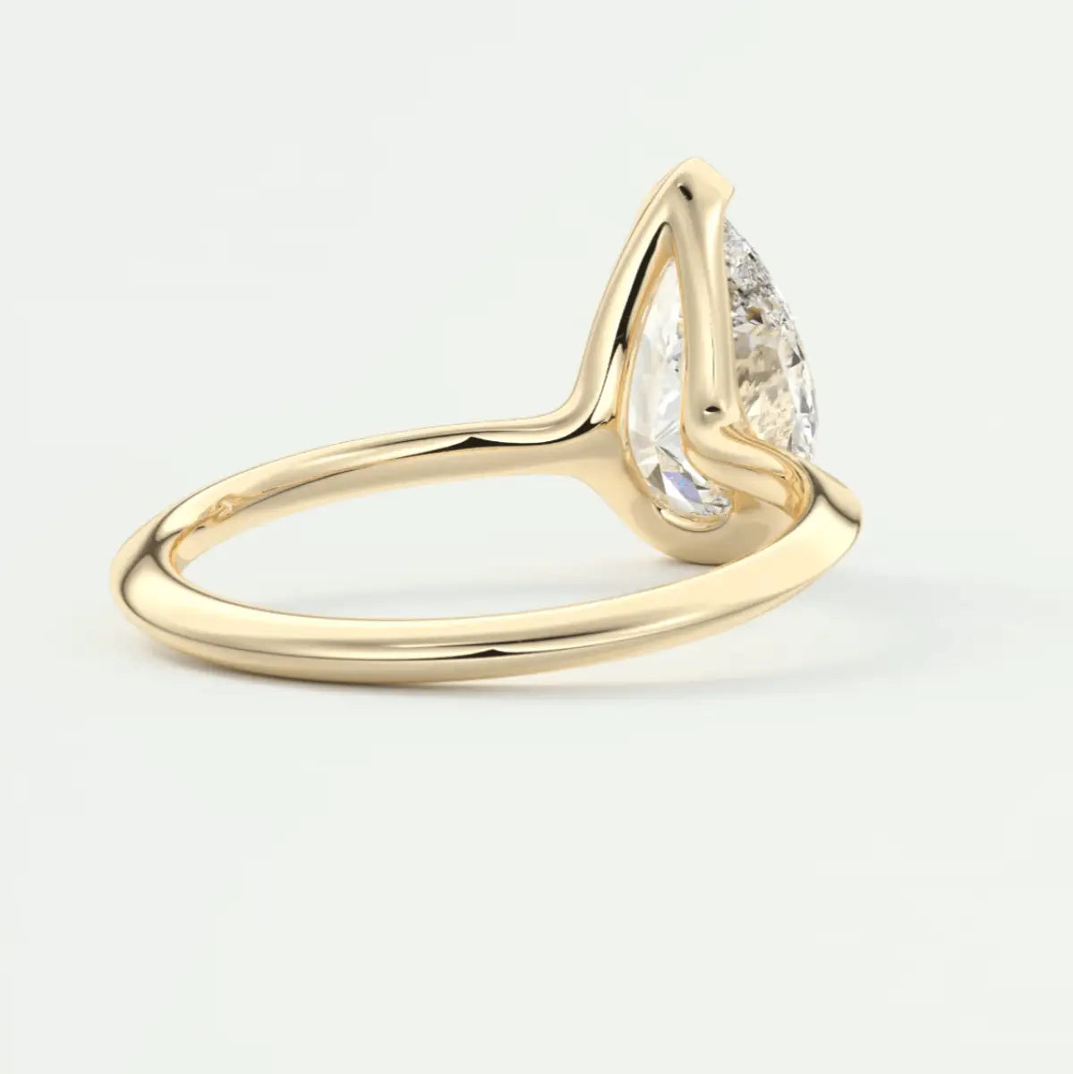 18k yellow gold pear-shaped diamond engagement ring.