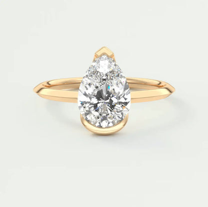 18-karat yellow gold pear-shaped diamond engagement ring.