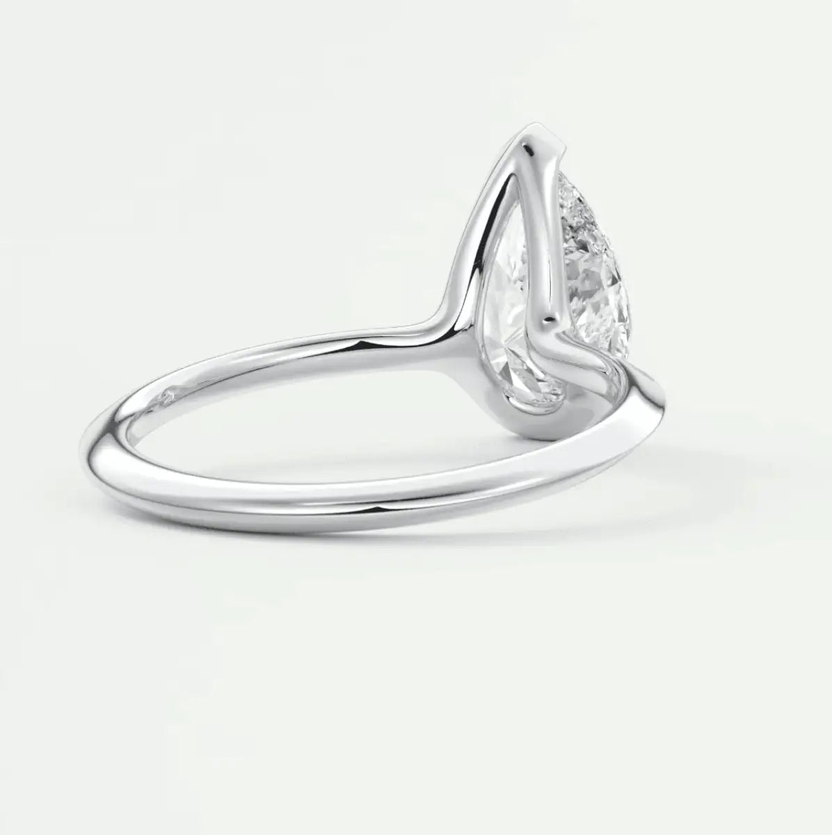 Pear-shaped diamond engagement ring with white gold band, featuring a classic solitaire design.