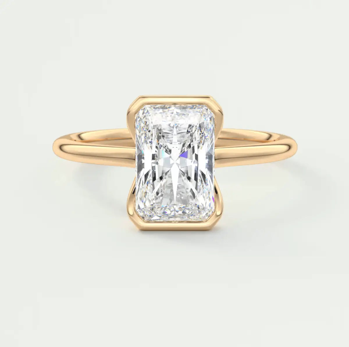 18k yellow gold engagement ring with a radiant cut diamond.