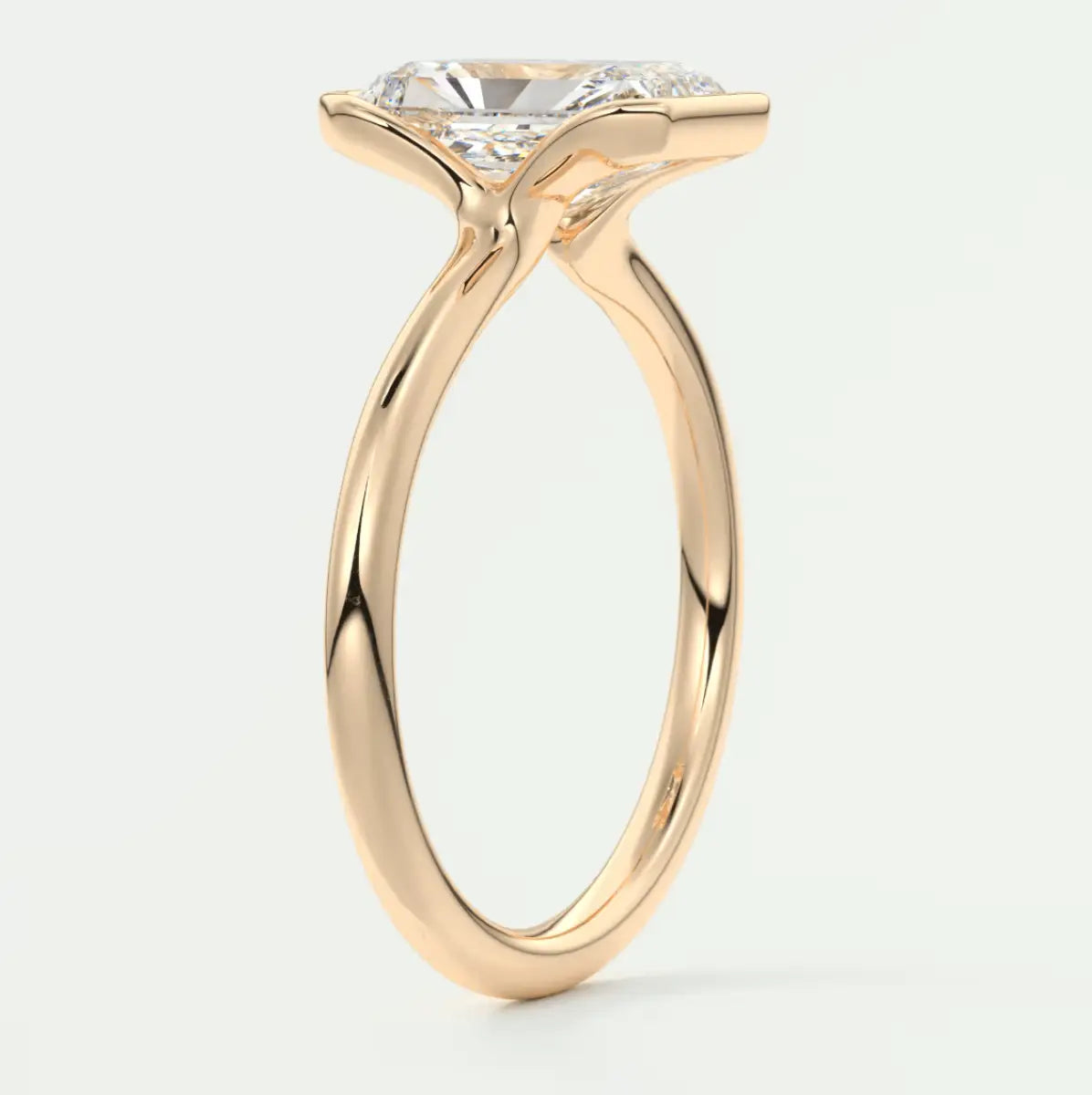 18-karat rose gold engagement ring with a cushion-cut diamond.