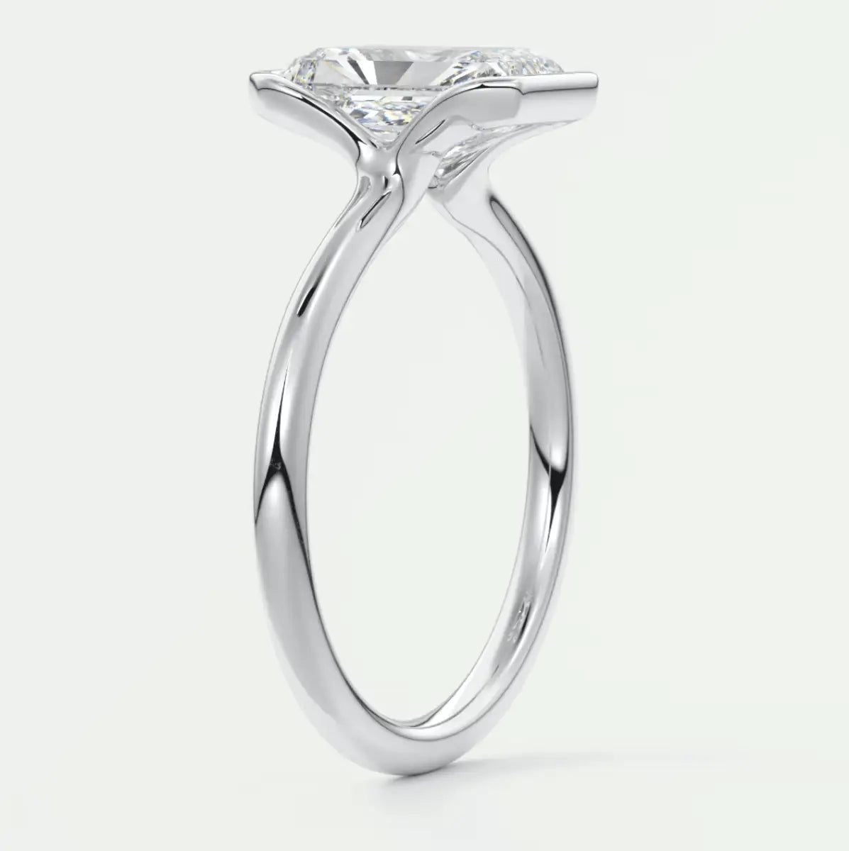 18-karat white gold solitaire engagement ring with a round diamond.