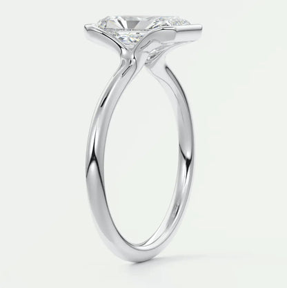 18-karat white gold solitaire engagement ring with a round diamond.