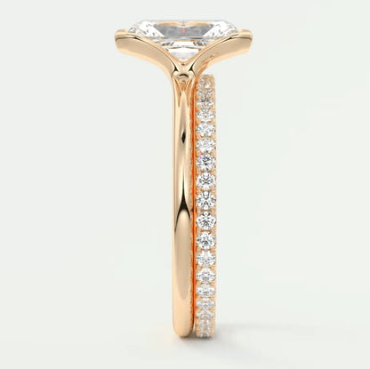 18k rose gold engagement ring with princess cut diamond and pave set diamonds on the band.