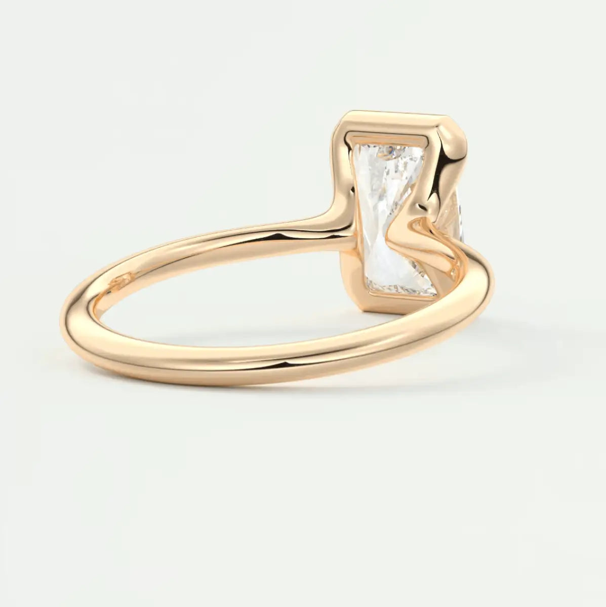 18k gold engagement ring with a rectangular diamond.