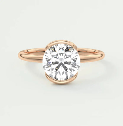 18-karat rose gold diamond engagement ring with a round-cut center stone.
