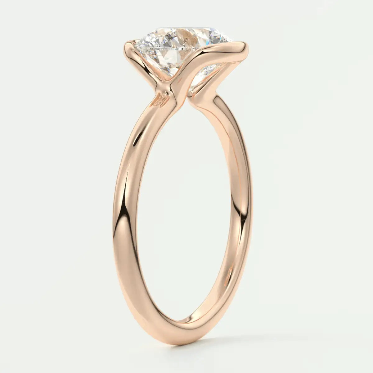18k rose gold solitaire diamond engagement ring with a princess cut stone.