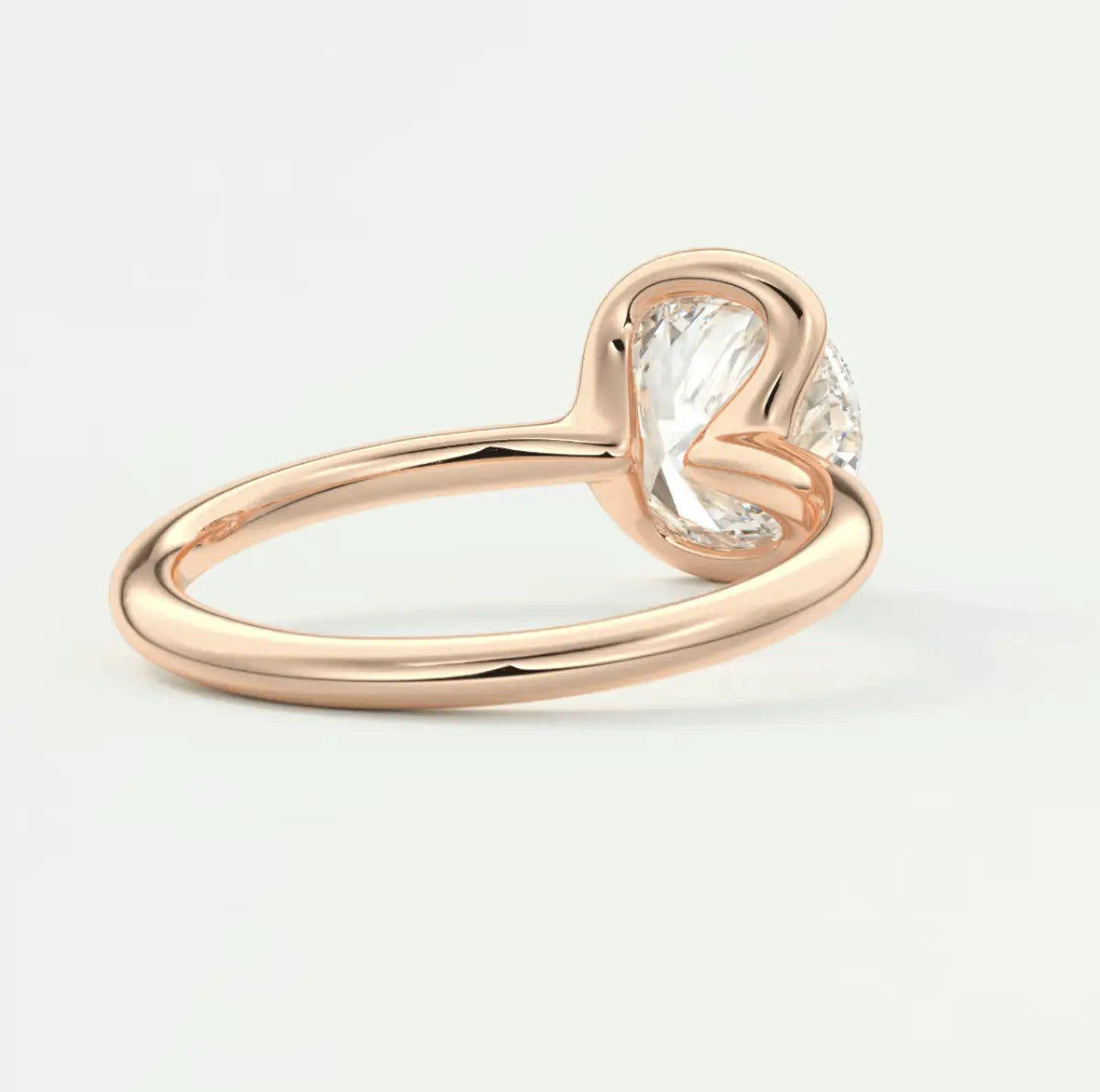 Rose gold engagement ring with a cushion-cut diamond.