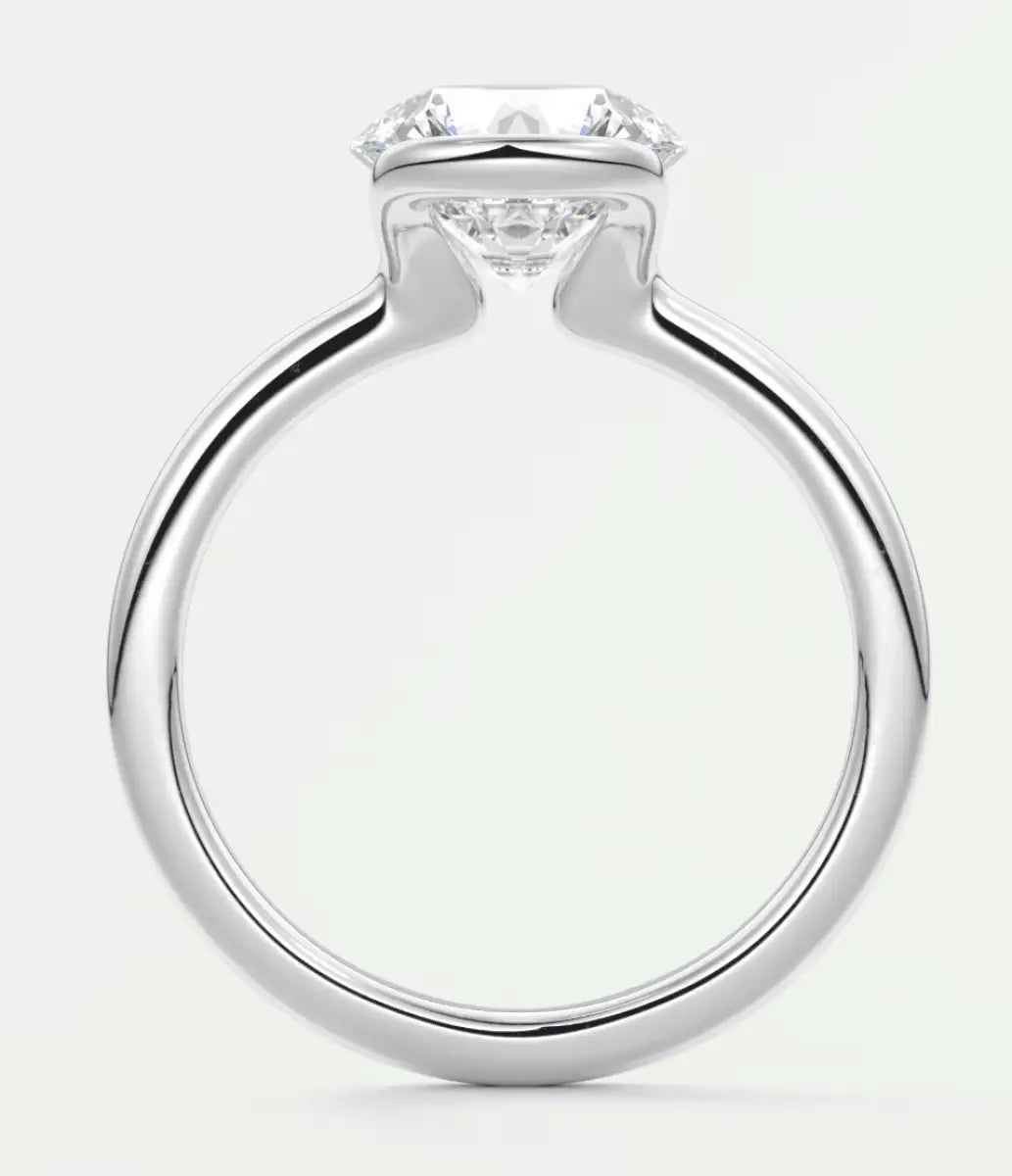 18k white gold engagement ring with a round diamond center stone and four prongs.