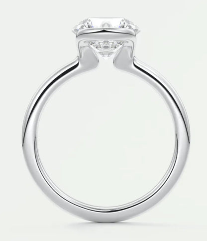 18k white gold engagement ring with a round diamond center stone and four prongs.