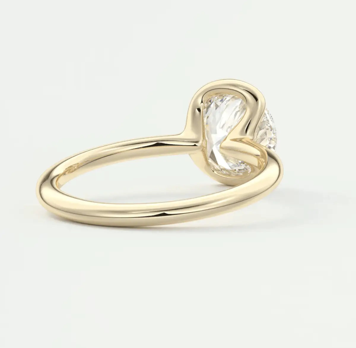 18k yellow gold engagement ring with a cushion-cut diamond.