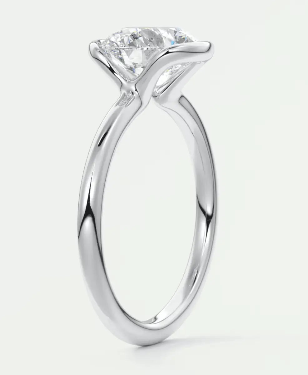White gold solitaire engagement ring with a princess cut diamond.