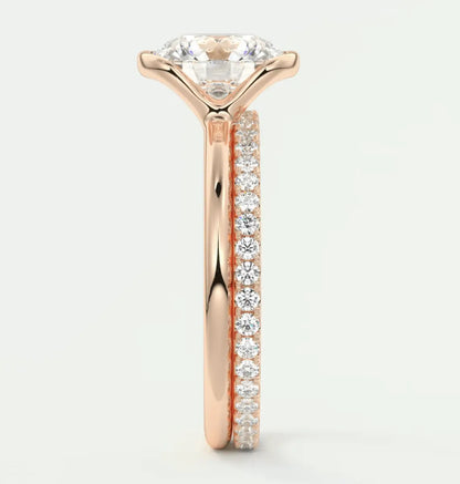 18k rose gold diamond engagement ring with a round brilliant cut center stone and pave set diamonds on the band.