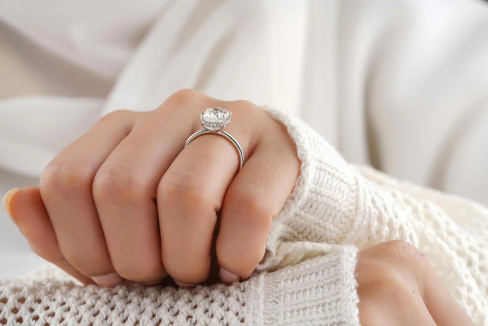 A sparkling solitaire diamond ring in a sleek platinum band, elegantly set on a finger.