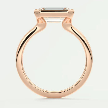 Rose gold emerald cut diamond engagement ring with a sleek, modern design.