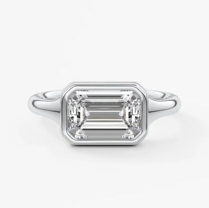 18k white gold emerald cut diamond engagement ring with baguette side stones.