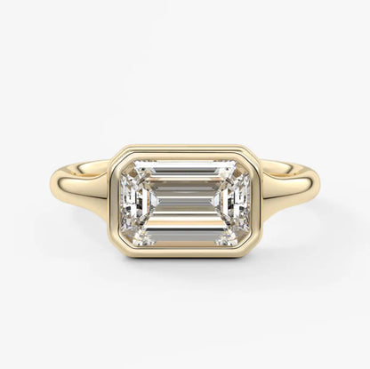 18-karat yellow gold emerald-cut diamond engagement ring.