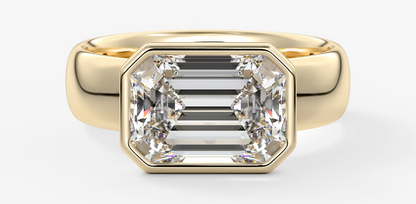 Gold ring with a large diamond on a white background