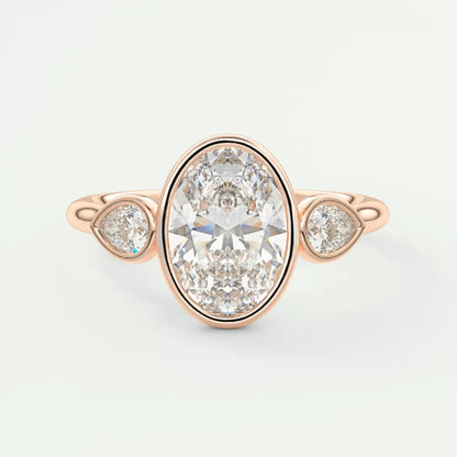 Rose gold diamond engagement ring with three pear-shaped diamonds set in a bezel setting.