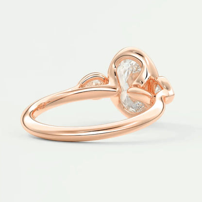 Rose gold heart-shaped diamond engagement ring with a single large central stone and two smaller side stones.