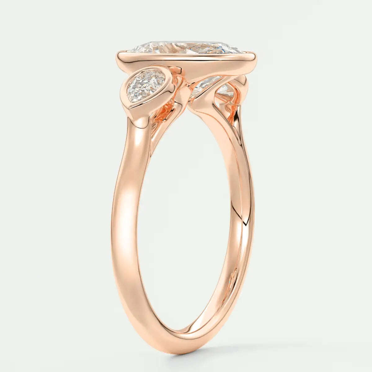 Rose gold engagement ring with a cushion-cut diamond and smaller diamonds on the band, featuring an elegant floral design.