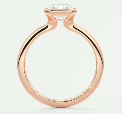 Rose gold diamond engagement ring with a marquise-cut center stone and sleek band design.
