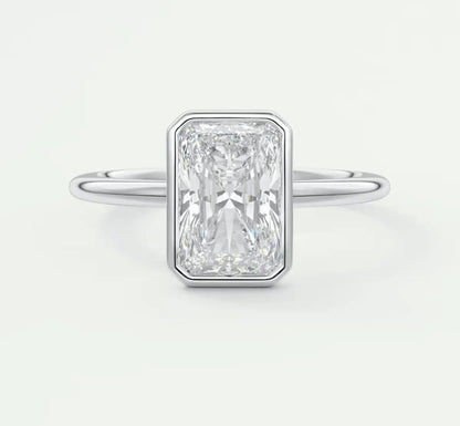 18-karat white gold engagement ring with an emerald-cut diamond.