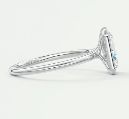 18k white gold diamond engagement ring with a marquise-shaped center stone and turquoise accents.