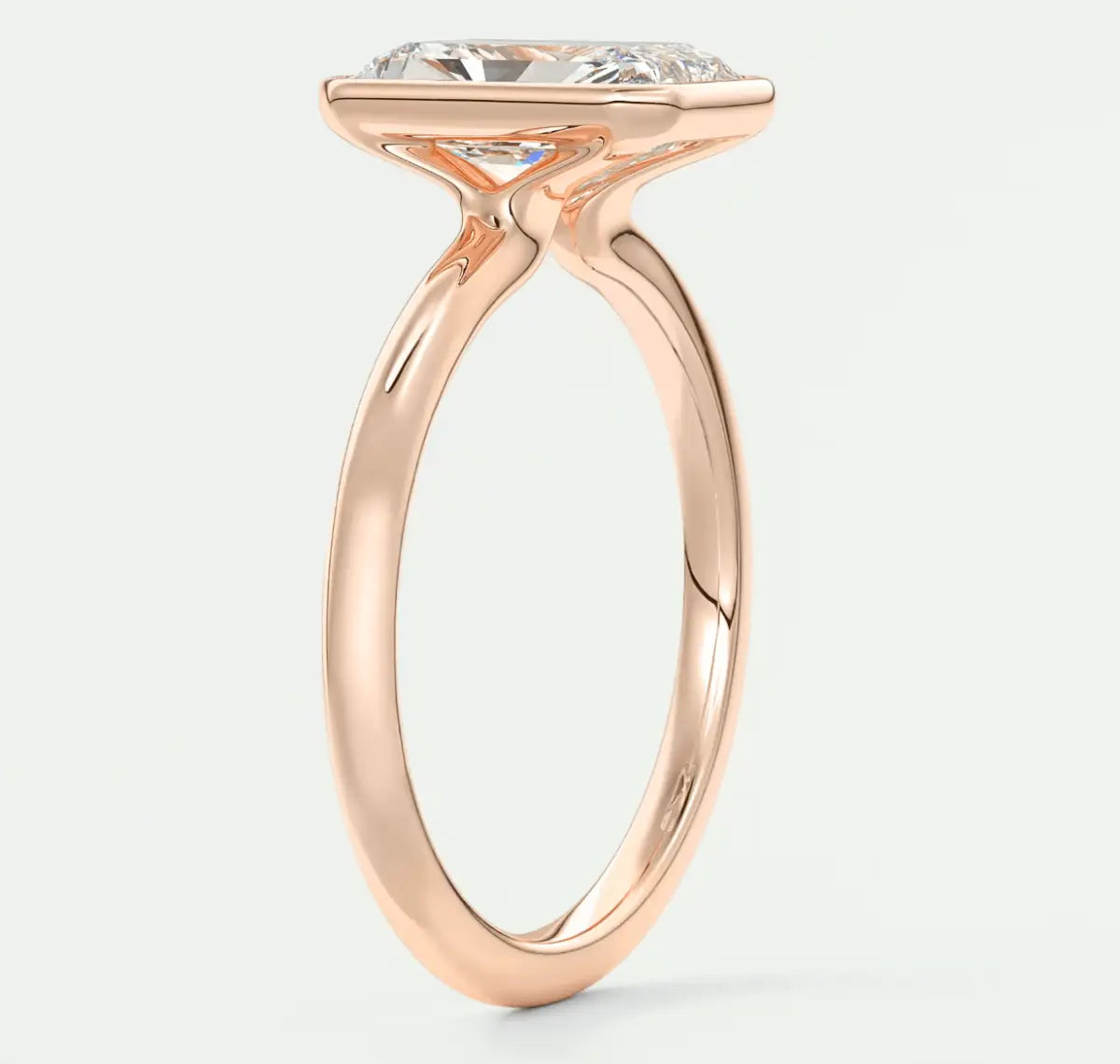 Rose gold engagement ring with a large, cushion-cut diamond.