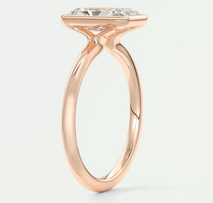 Rose gold engagement ring with a large, cushion-cut diamond.
