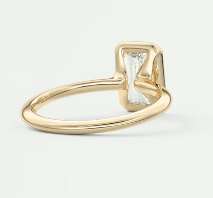 18k yellow gold engagement ring with a baguette diamond and small accent diamonds.