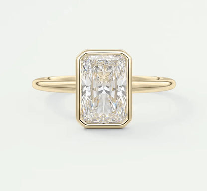 18k yellow gold emerald cut diamond ring with a bezel setting.