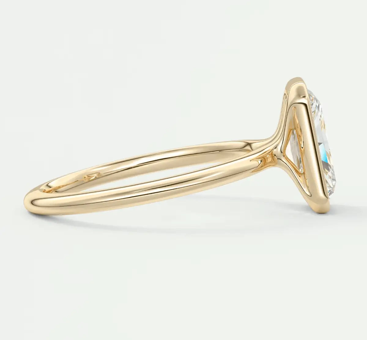 18k gold engagement ring with a blue gemstone and diamond accents.