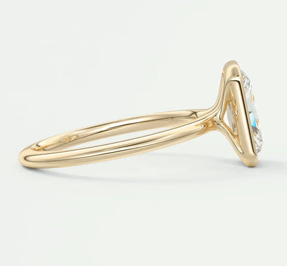 18k gold engagement ring with a blue gemstone and diamond accents.